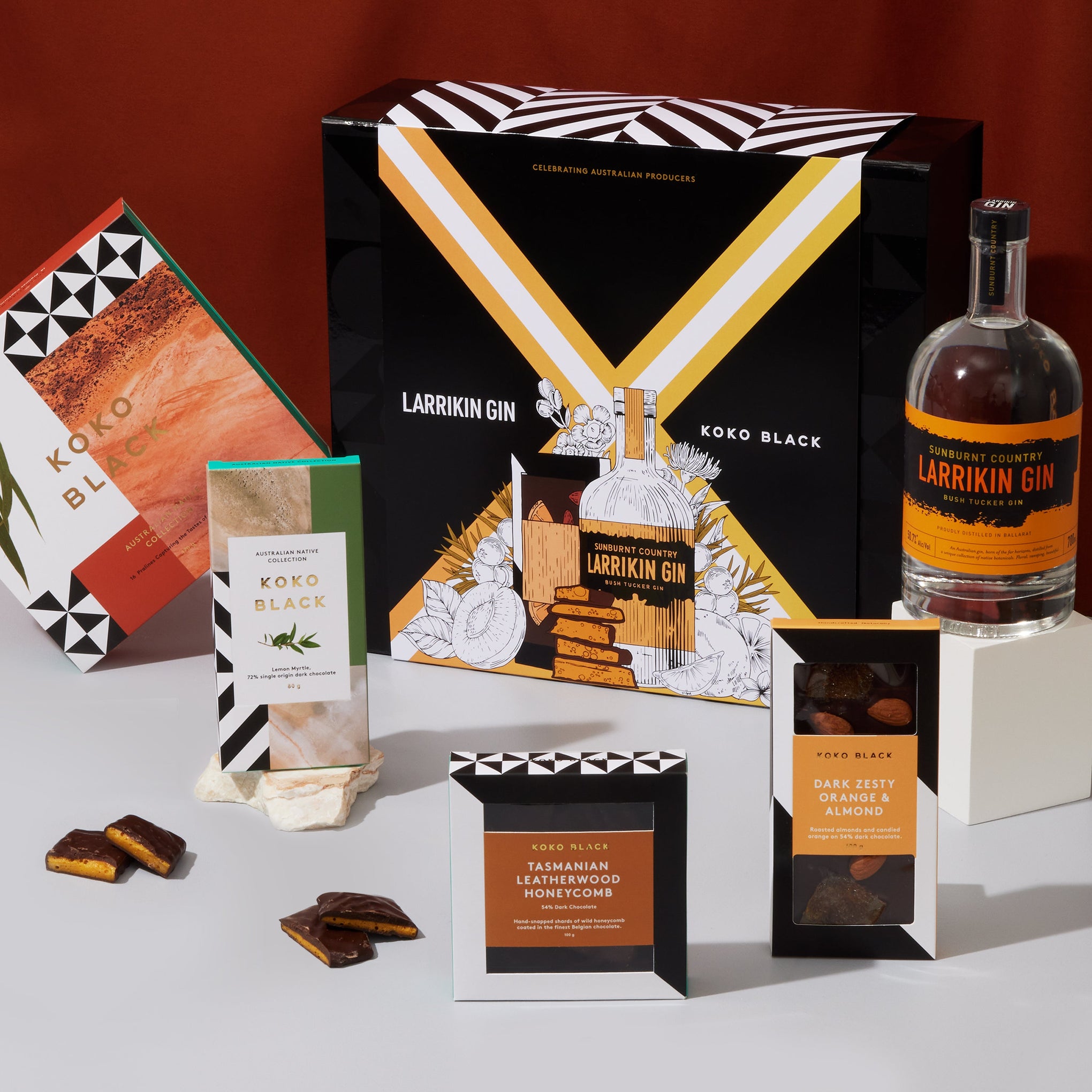 Dark chocolate with honeycomb and almond placed around gin bottle
