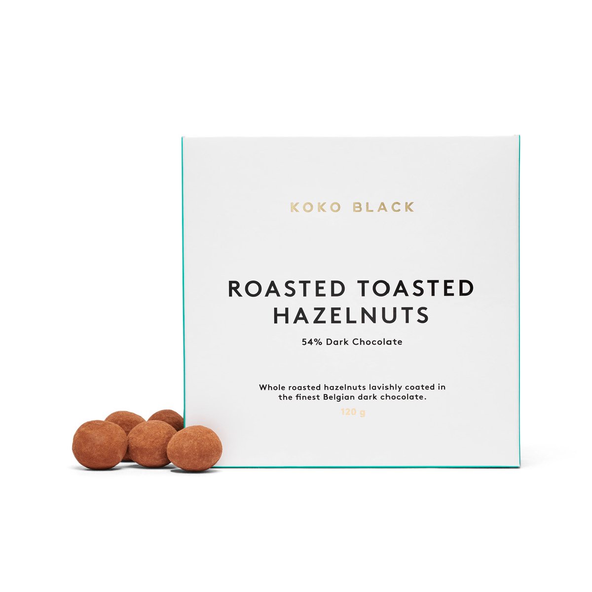 Chocolate hazelnuts beside packaging